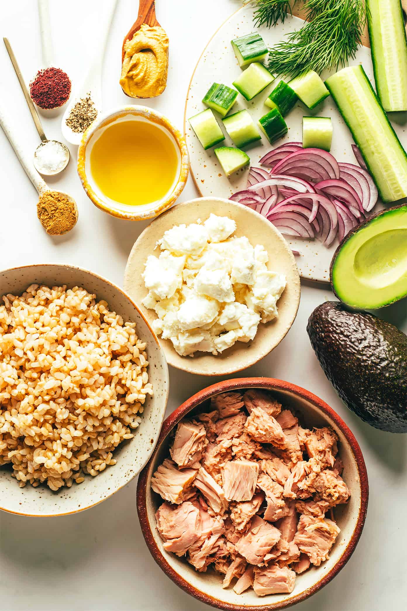 This simple tuna salad is tossed with avocado, cucumber, feta, red onions, herbs and a zippy lemon-sumac dressing and served over brown rice. Easy to make in about 30 minutes, naturally gluten-free, easy to meal prep in advance for lunch or dinner, and always SO delicious. | gimmesomeoven.com Tuna Salad Ingredients