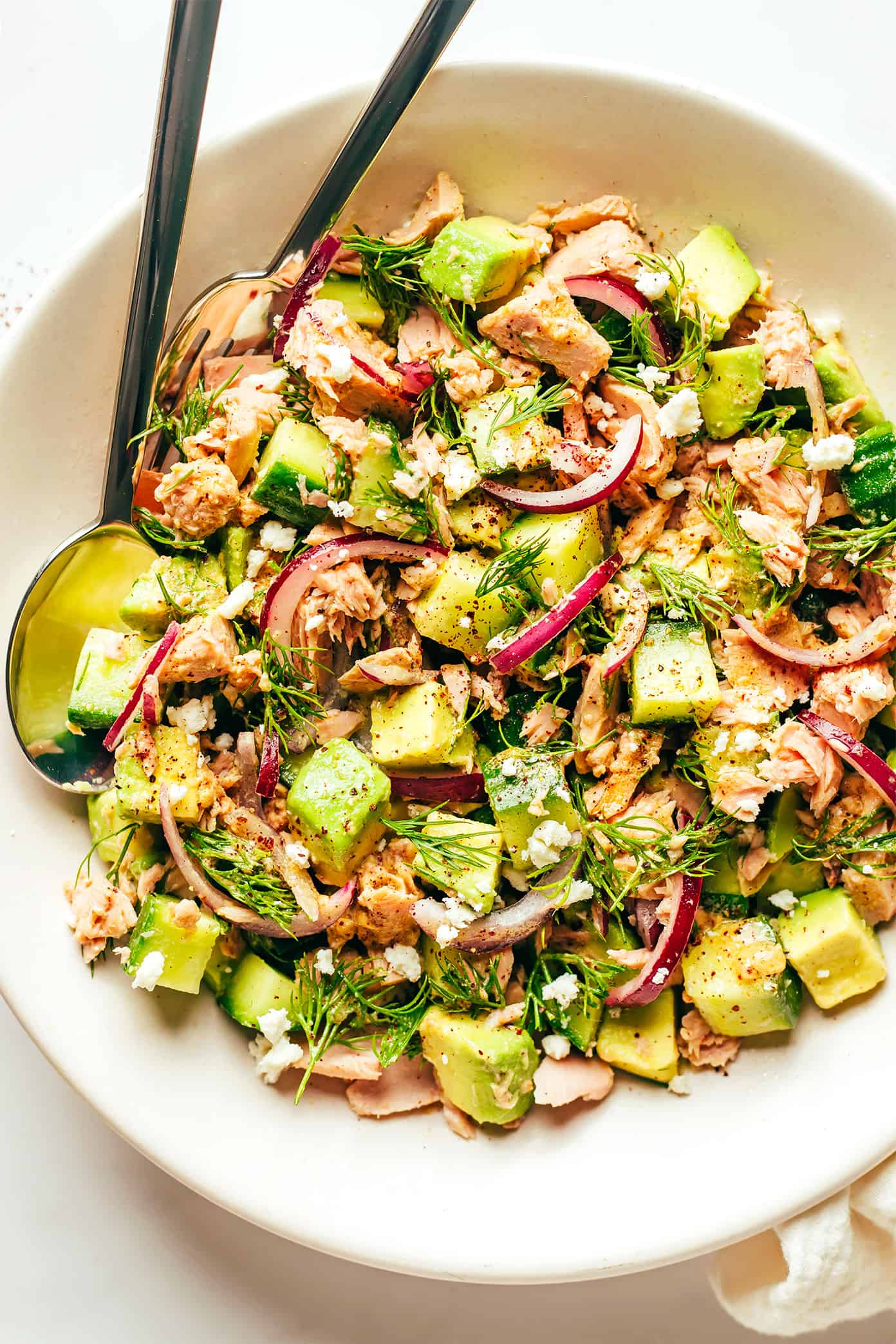 This simple tuna salad is tossed with avocado, cucumber, feta, red onions, herbs and a zippy lemon-sumac dressing and served over brown rice. Easy to make in about 30 minutes, naturally gluten-free, easy to meal prep in advance for lunch or dinner, and always SO delicious. | gimmesomeoven.com Tuna Avocado Salad with Dill In Bowl
