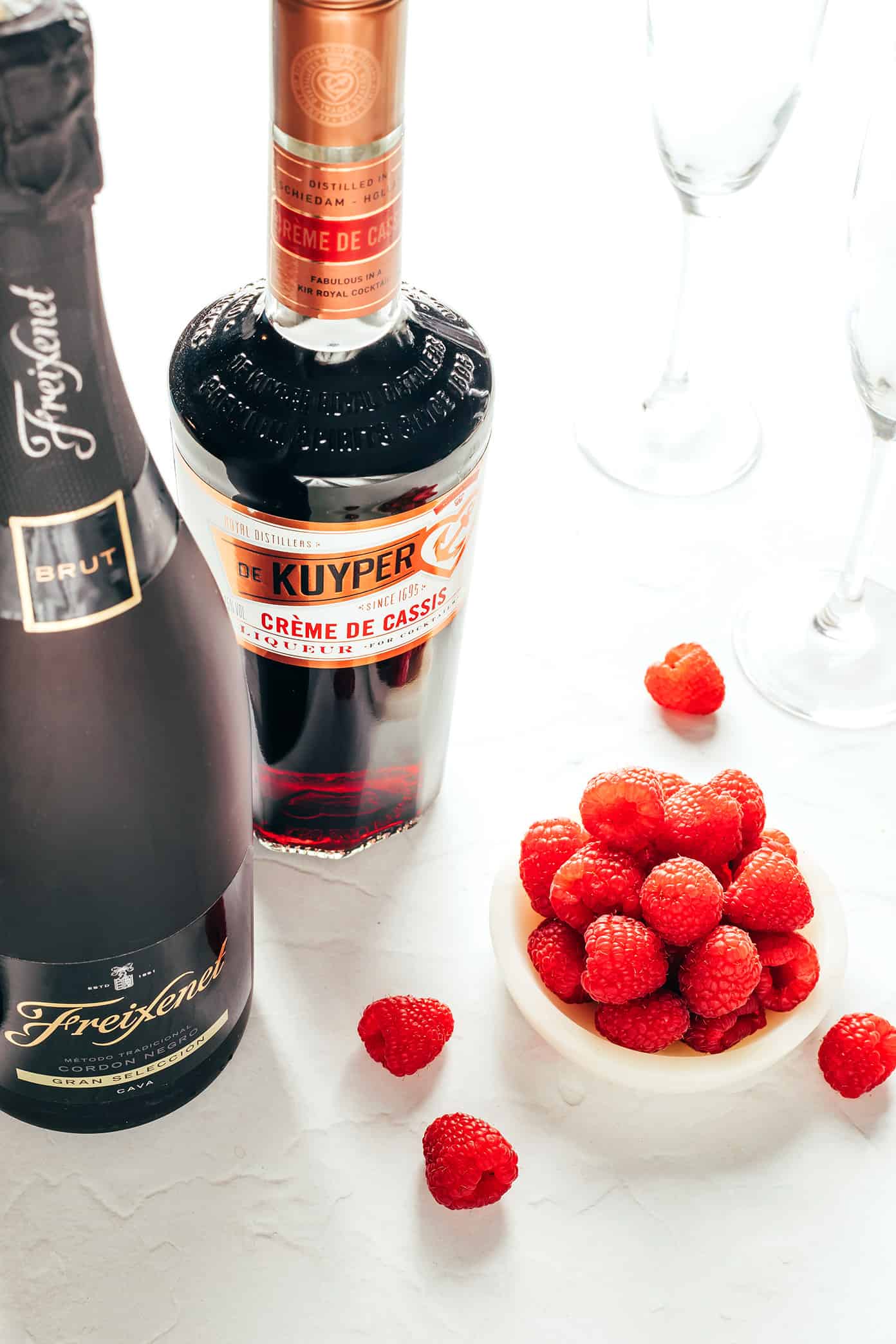 This classic kir royale cocktail recipe is easy to make with dry sparkling wine (such as Champagne, cava or prosecco), crème de cassis (blackcurrant liqueur) and your choice of berries for garnish. It's a vibrant, bubbly, refreshing drink that's perfect for summertime! | gimmesomeoven.com Kir Royale Ingredients