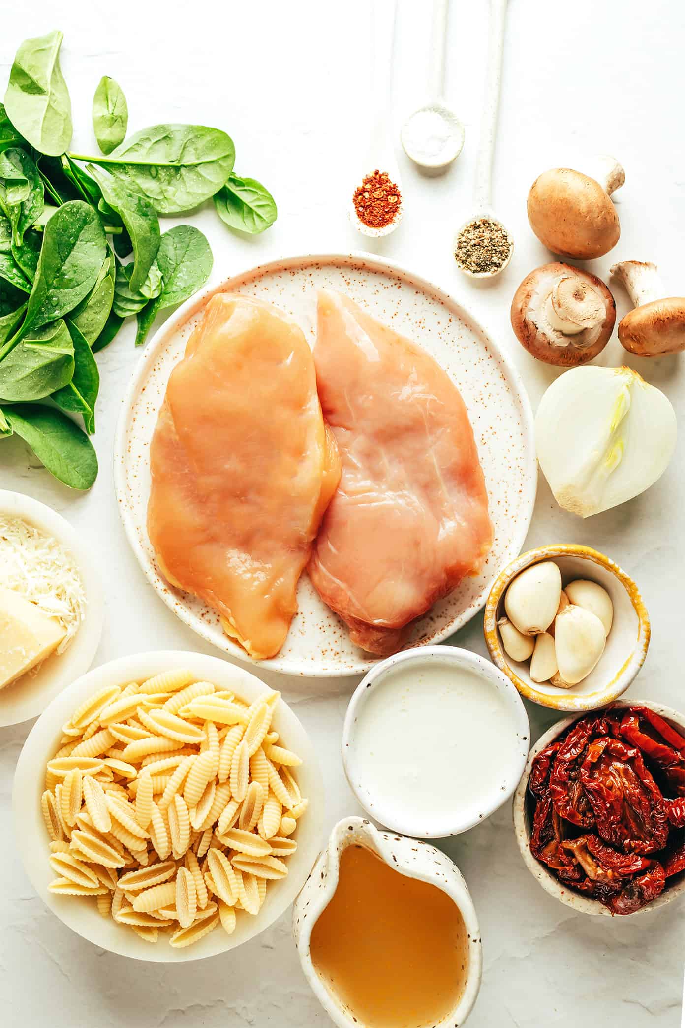 This one pot creamy sun-dried tomato pasta recipe is made with chicken, mushrooms and spinach in a rich garlic basil sauce. Serve topped with lots of Parmesan and enjoy! | gimmesomeoven.com One Pot Creamy Sun-Dried Tomato Pasta Ingredients