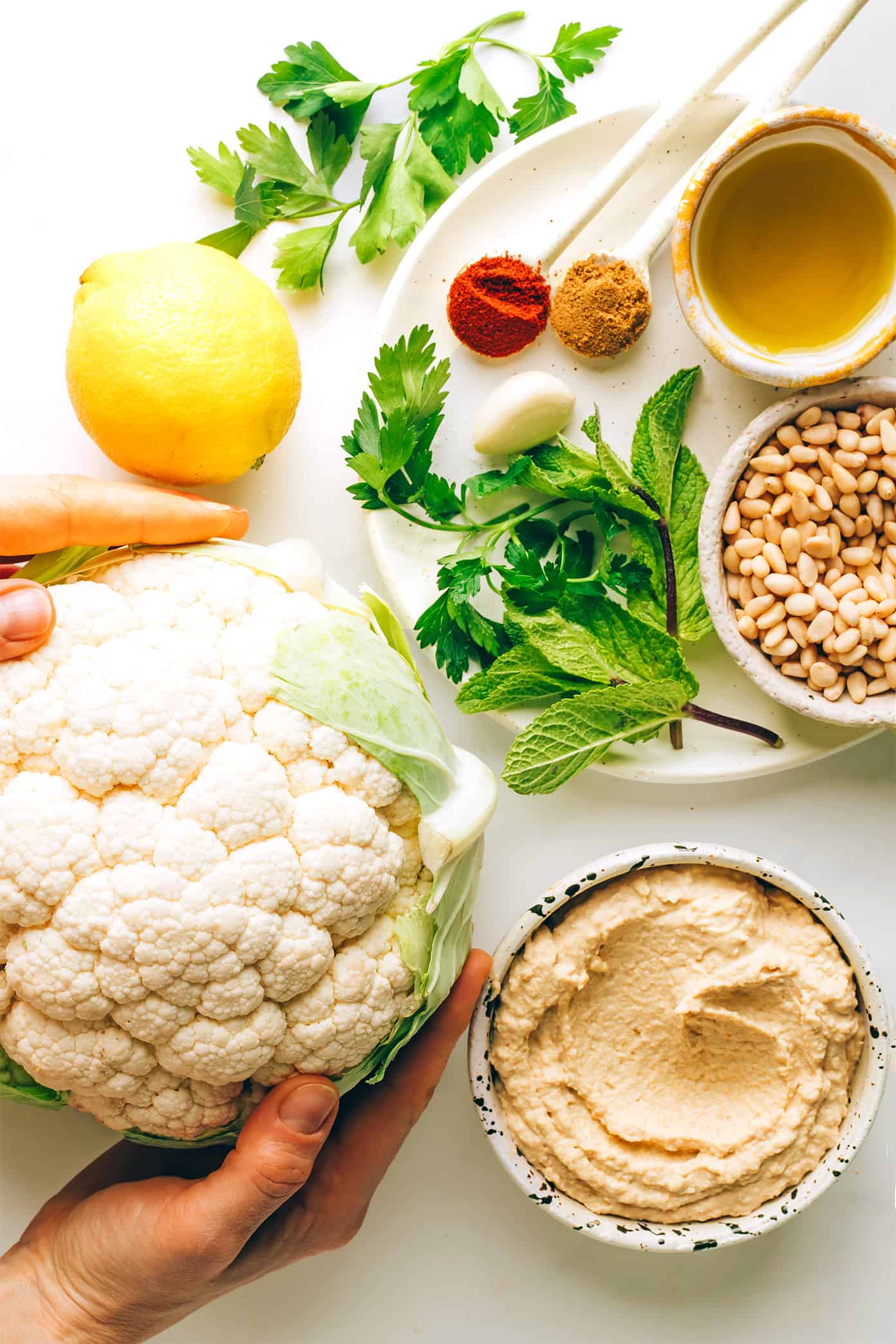 Zesty cauliflower steaks are served over hummus and sprinkled with a lemon-mint pine nut gremolata. A simple, healthy and absolutely delicious dinner recipe that also happens to be vegetarian, vegan and gluten-free. | gimmesomeoven.com Cauliflower Steaks with Hummus and Gremolata