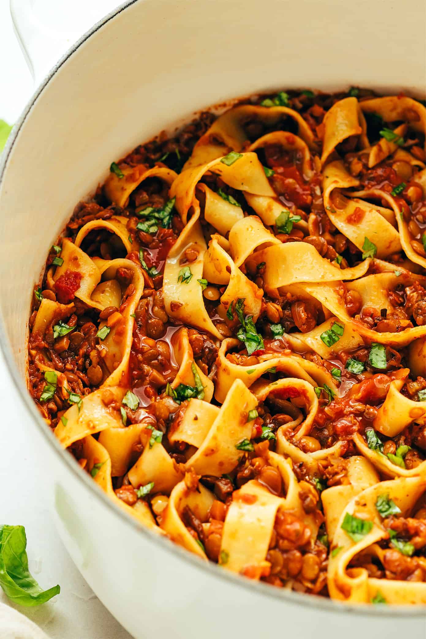 This hearty lentil bolognese recipe is naturally gluten-free, vegetarian and vegan and simmered with a garlicky mushroom-herb tomato sauce. Feel free to serve for dinner with pasta, gnocchi, mashed potatoes, polenta or whatever sounds good! | gimmesomeoven.com Lentil pasta alla bolognese in pot