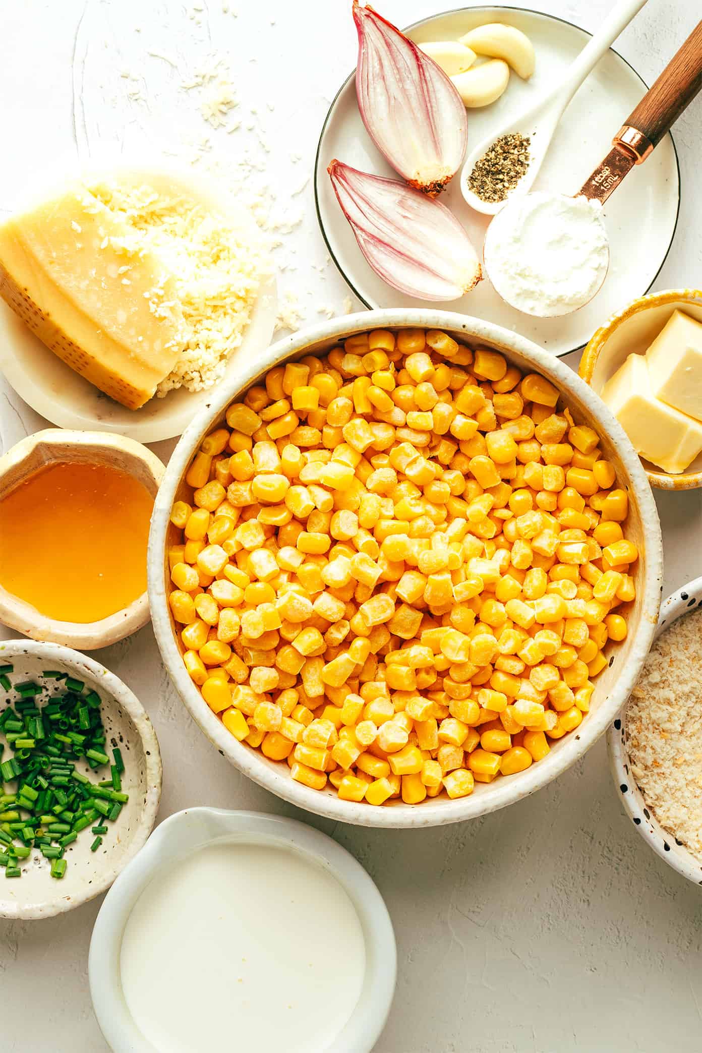 This Parmesan Creamed Corn recipe is layered with sweet and savory flavors, perfectly creamy and cheesy, and sprinkled with irresistible crispy toasted garlic breadcrumbs. Perfect for the holidays, such as Thanksgiving or Christmas, or for any weeknight dinner that needs a simple side dish! | gimmesomeoven.com Parmesan Creamed Corn Ingredients