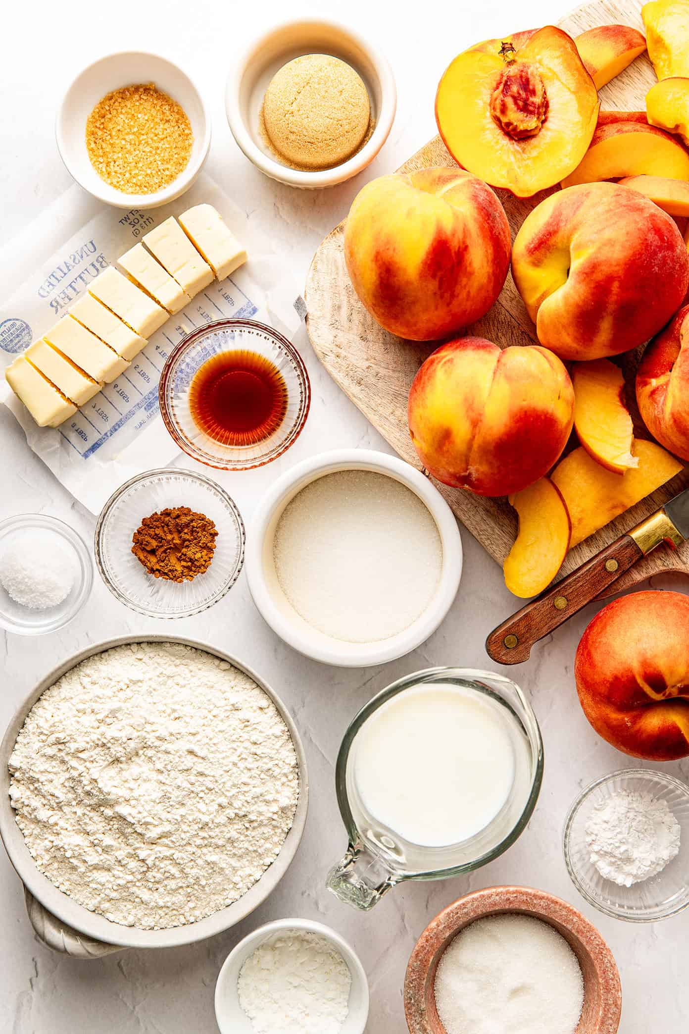 This easy peach cobbler recipe features a juicy cinnamon-vanilla peach filling and a golden buttery biscuit topping -- the perfect dessert to celebrate fresh peach season! | gimmesomeoven.com fresh peach cobbler ingredients