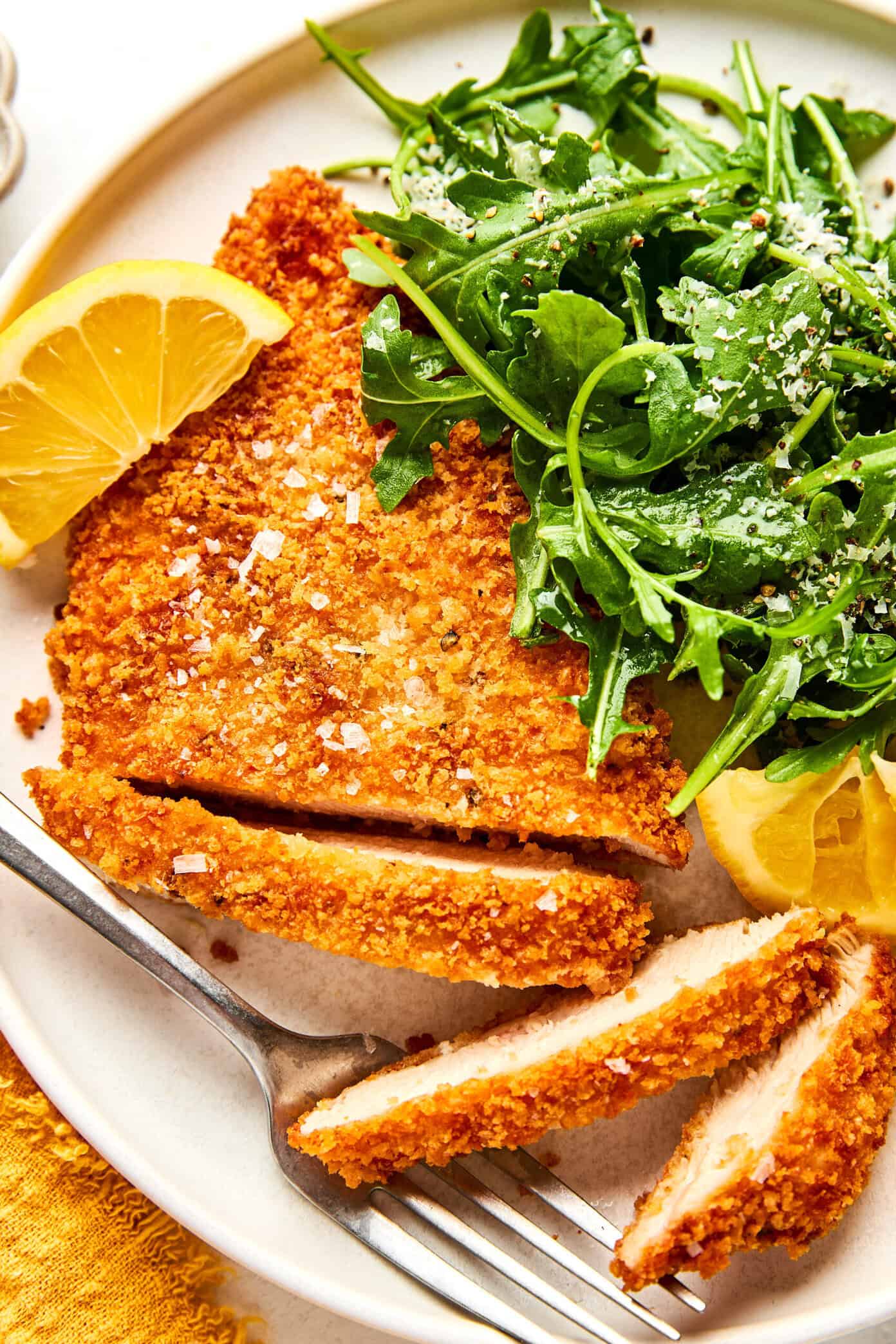 crispy chicken milanese with arugula salad and flaky sea salt