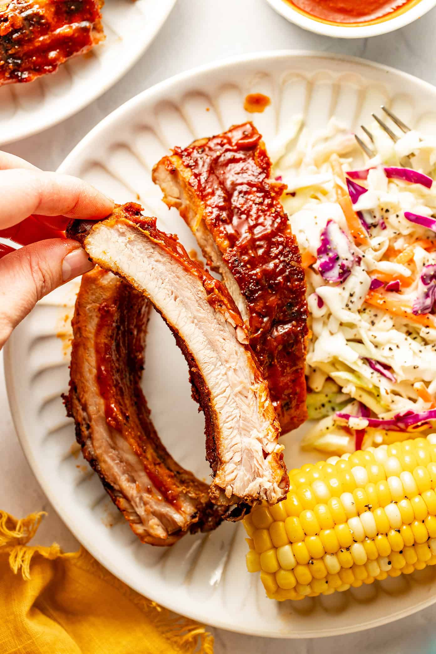 oven roasted baby back ribs with cole slaw and corn on the cob