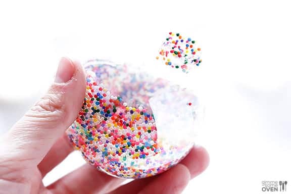 DIY Sprinkles Ornaments | gimmesomeoven.com/style #christmas #diy #ornament #sprinkles These DIY Sprinkles Ornaments are easy to make and customize with your favorite colors of sprinkles. The perfect homemade decor for your Christmas tree this year! | Gimme Some Oven