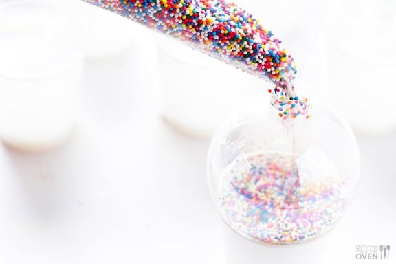 DIY Sprinkles Ornaments | gimmesomeoven.com/style #christmas #diy #ornament #sprinkles These DIY Sprinkles Ornaments are easy to make and customize with your favorite colors of sprinkles. The perfect homemade decor for your Christmas tree this year! | Gimme Some Oven